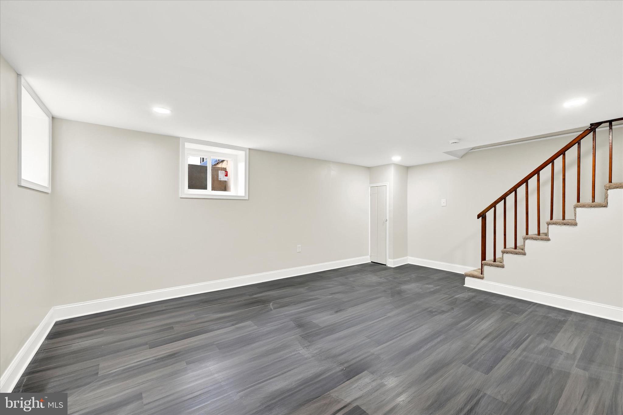 3940 Penhurst Avenue Baltimore, MD 21215 - Photo 19 of 24 a view of an empty room with wooden floor and a window