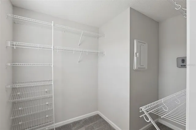 a view of walk in closet with empty racks