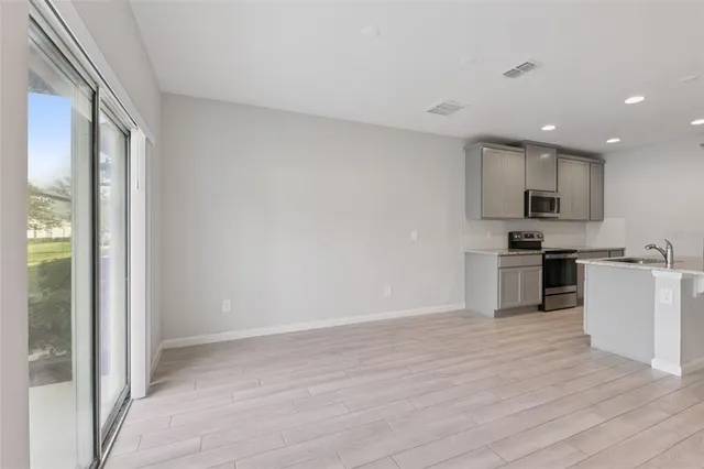 a view of kitchen with granite countertop cabinets and steel stainless steel appliances