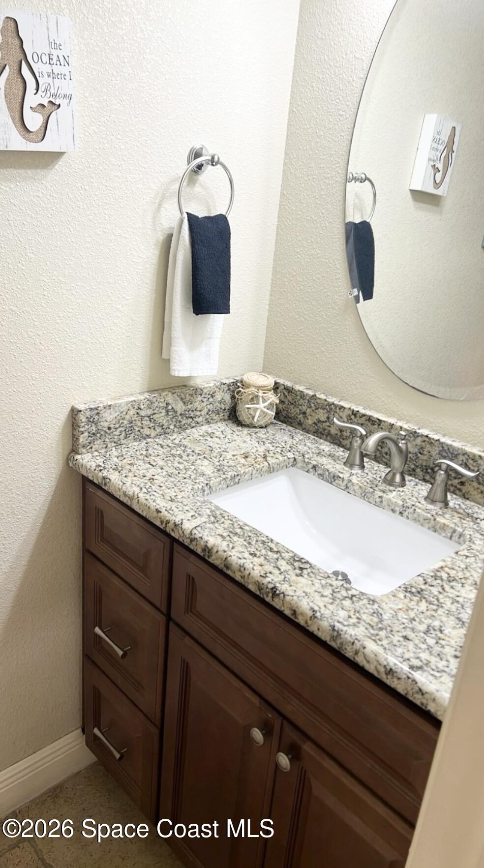2709 Cutlass Point Lane, Unit 103 Merritt Island, FL 32953 - Photo 10 of 31 a bathroom with a granite countertop sink and a mirror