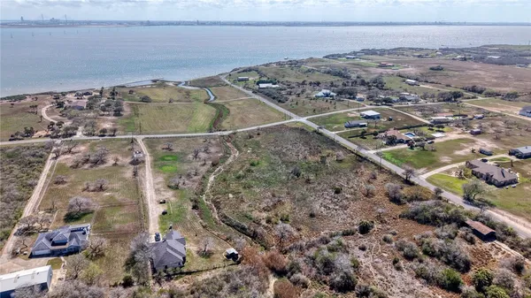a view of a backyard with wooden fence