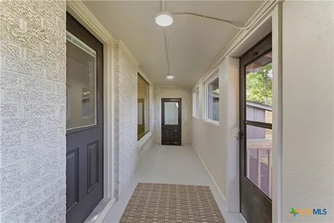a view of a patio with wooden floor