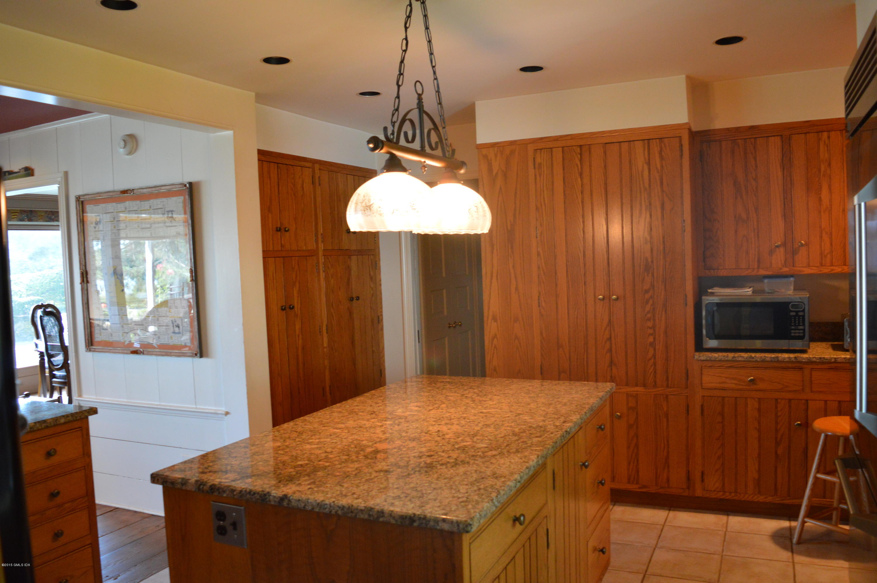 2 Bridle Path Lane Riverside, CT 06878 - Photo 17 of 24 a kitchen with stainless steel appliances granite countertop wooden cabinets a refrigerator and a sink