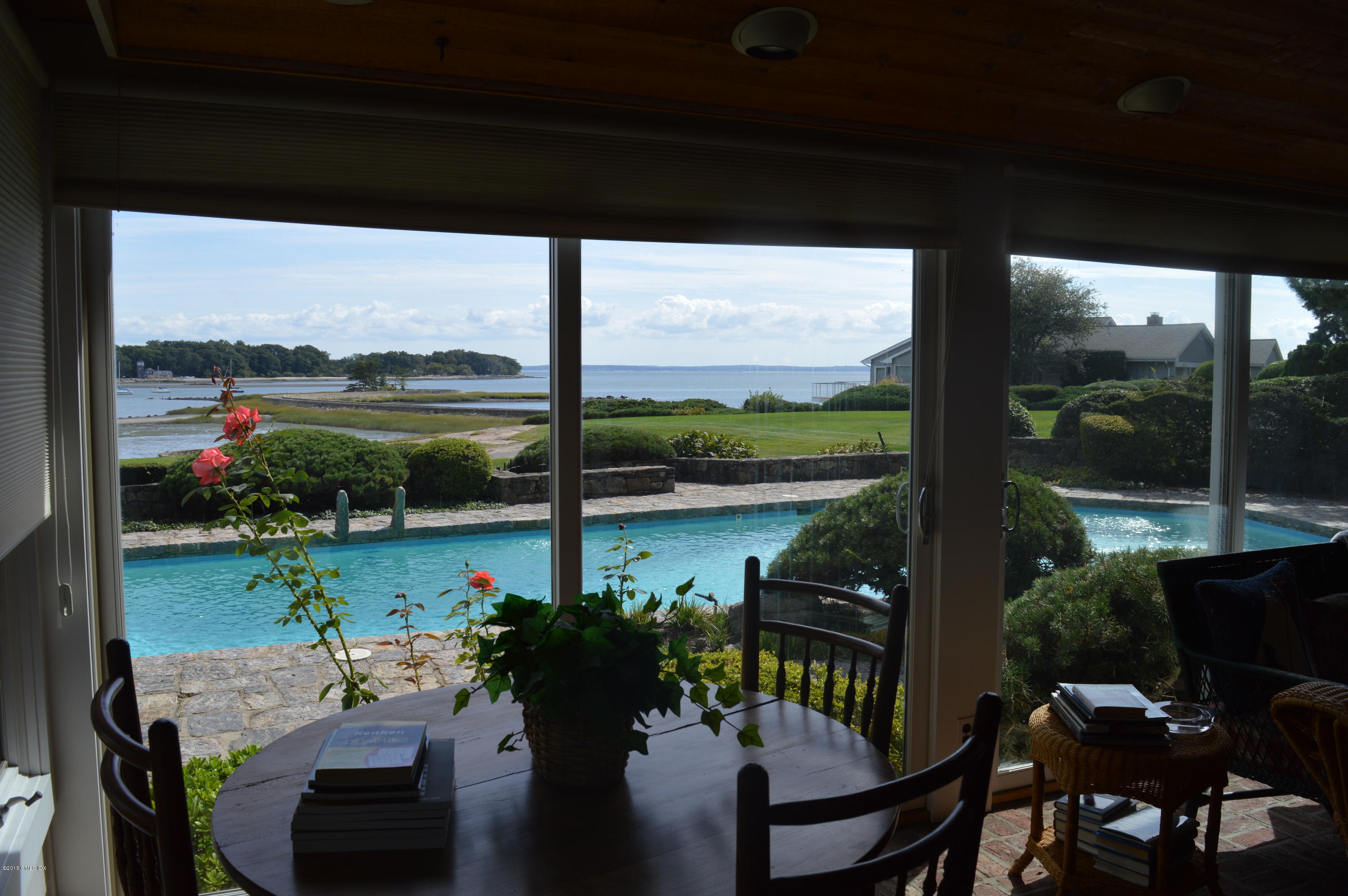 2 Bridle Path Lane Riverside, CT 06878 - Photo 20 of 24 a view of a lake from a balcony with chairs