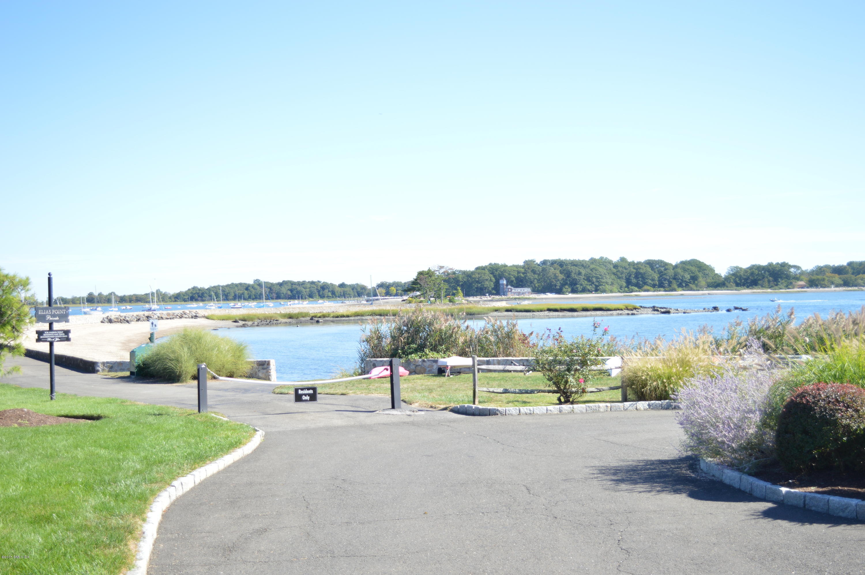 2 Bridle Path Lane Riverside, CT 06878 - Photo 6 of 24 a view of a lake view with a bench in front of lake
