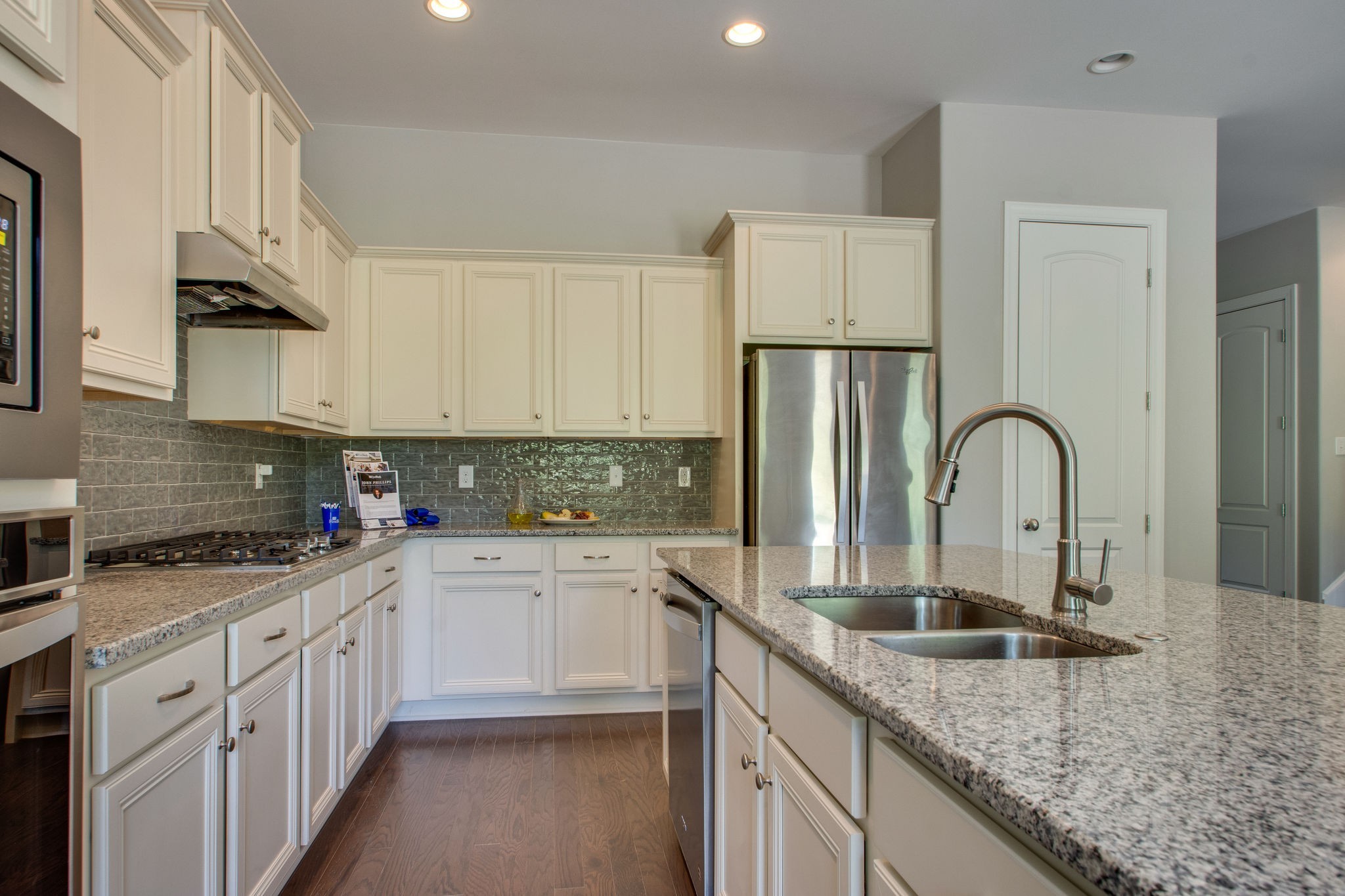 962 Hunters Lane Springfield, TN 37172 - Photo 6 of 10 a kitchen with granite countertop a sink stainless steel appliances and white cabinets