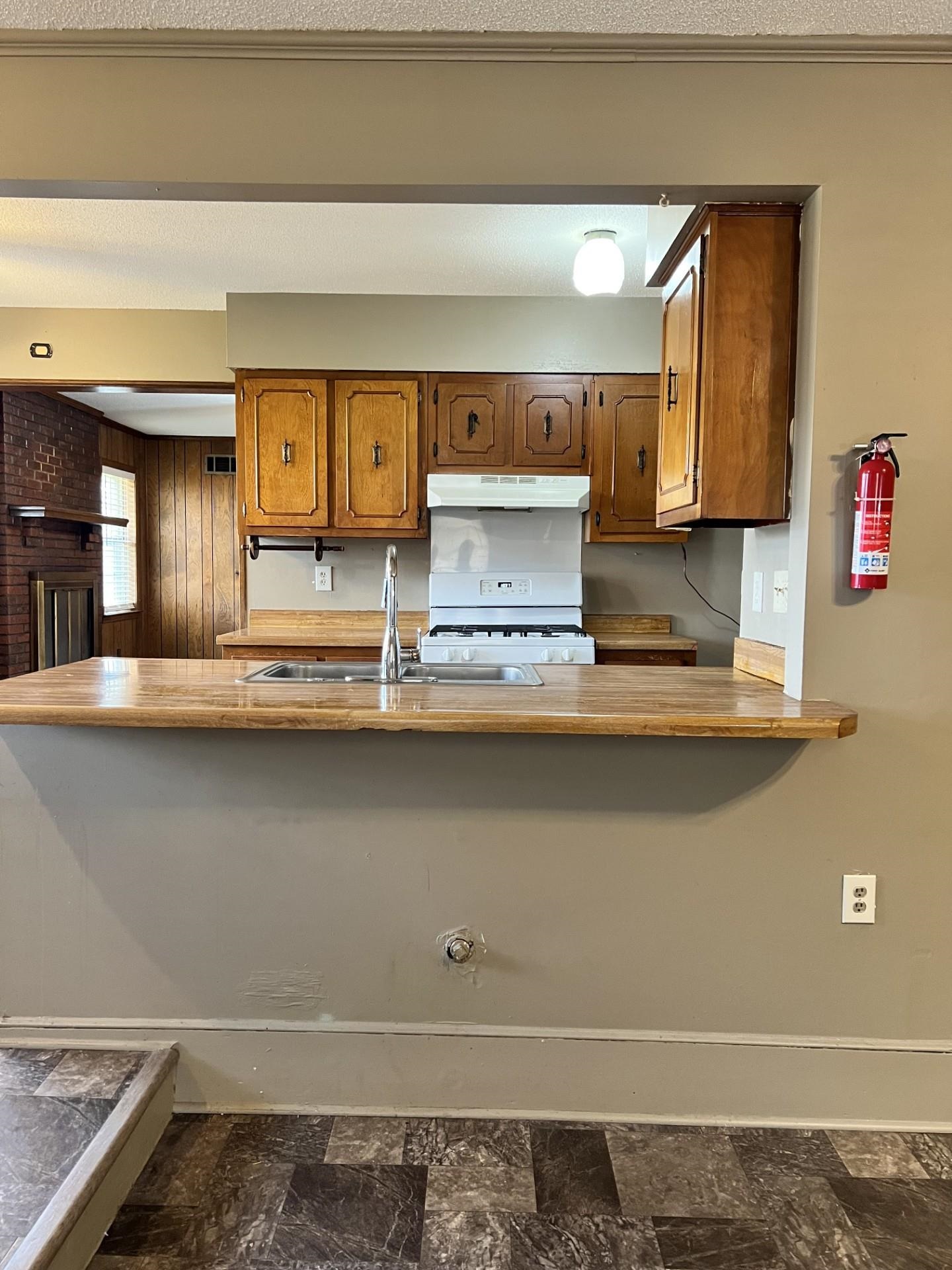 3472 Castleman Street Memphis, TN 38118 - Photo 12 of 30 a kitchen with a sink and a stove with wooden floor