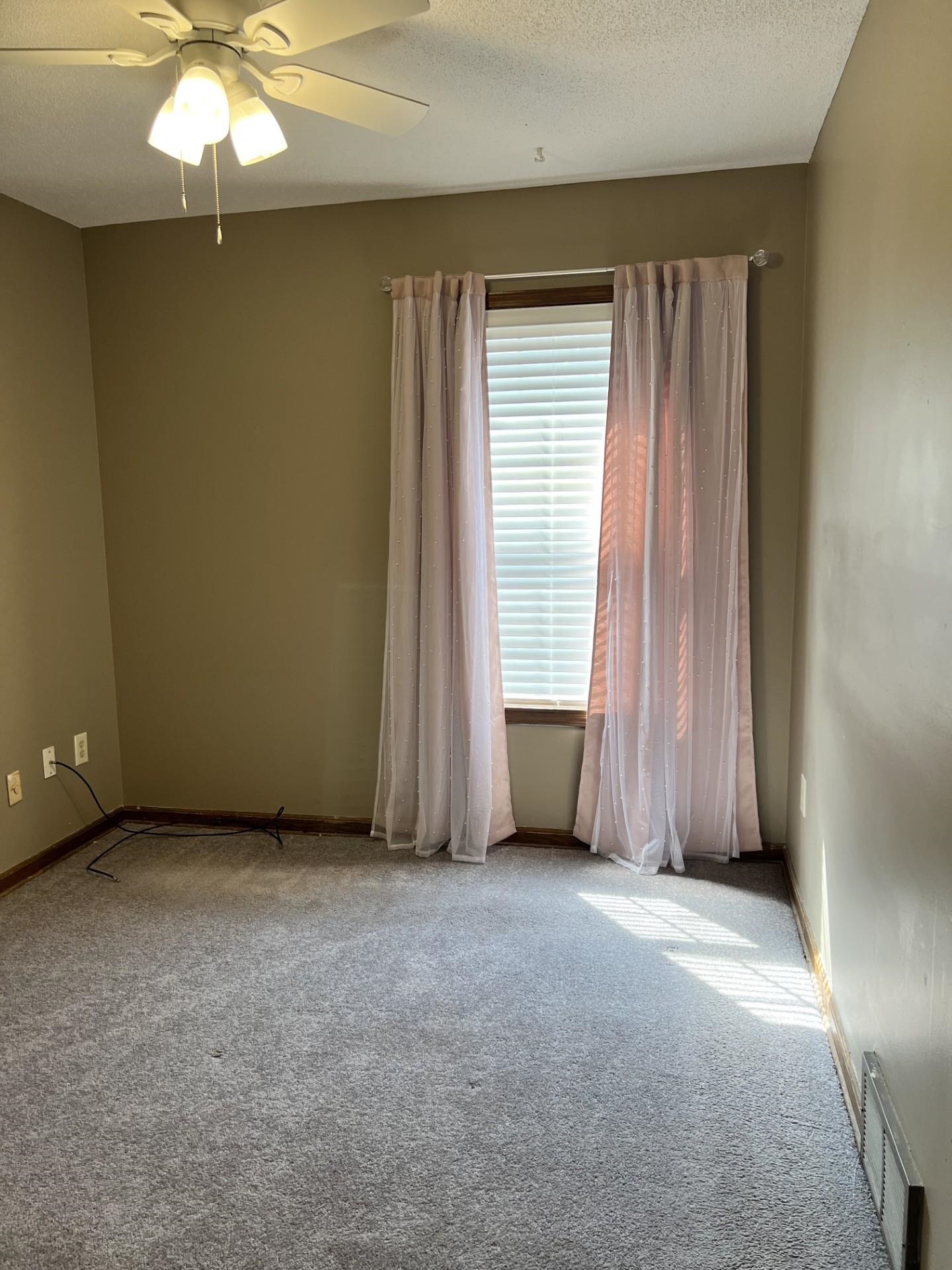 3472 Castleman Street Memphis, TN 38118 - Photo 20 of 30 an empty room with a window and a fan