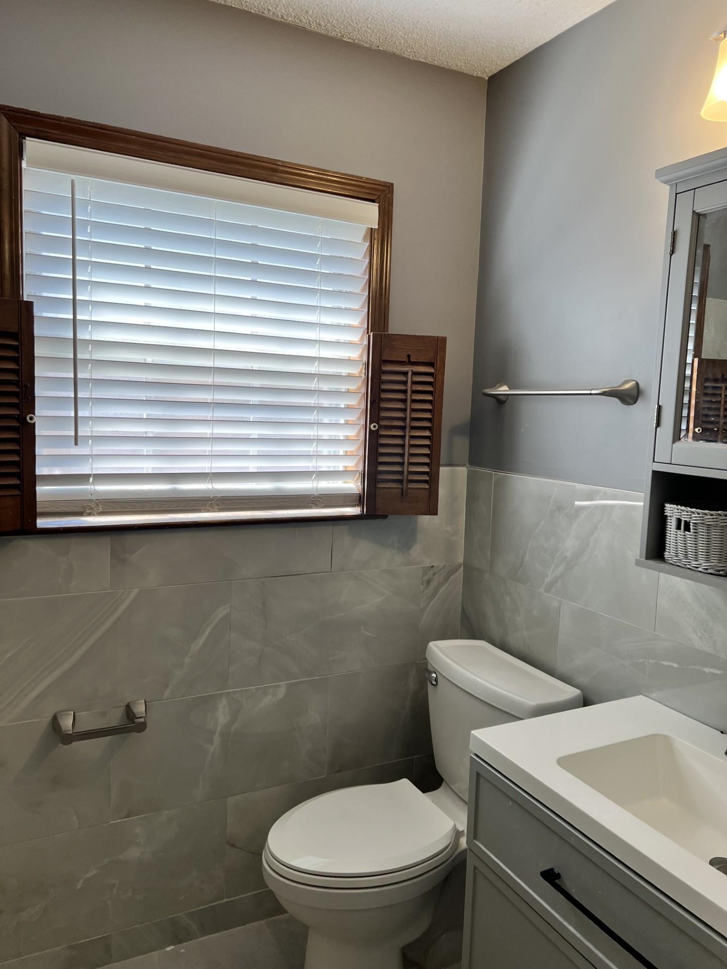 3472 Castleman Street Memphis, TN 38118 - Photo 23 of 30 a white toilet sitting next to a bathroom sink