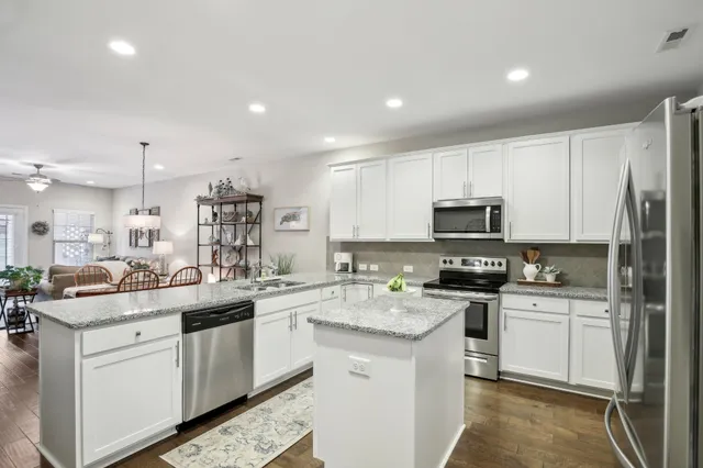 a kitchen with cabinets and stainless steel appliances