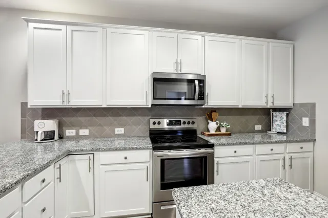 a room with a refrigerator and a sink
