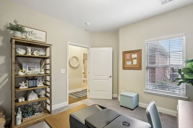 a work room with furniture and potted plant