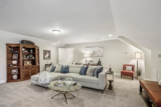 a living room with furniture and a clock