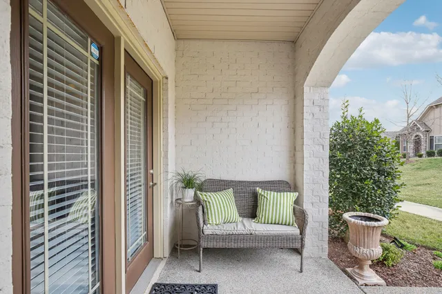a view of a house with a chairs in patio