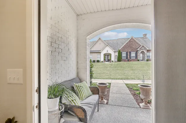 view of living room with furniture and a floor to ceiling window
