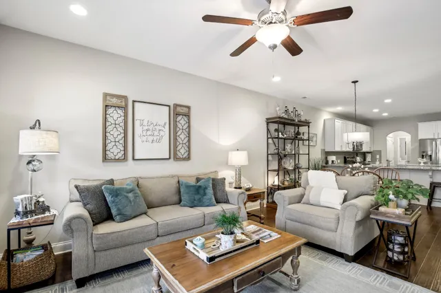 a living room with furniture a rug and a chandelier