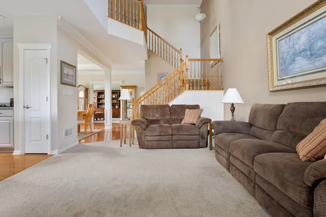 a living room with furniture and stairs