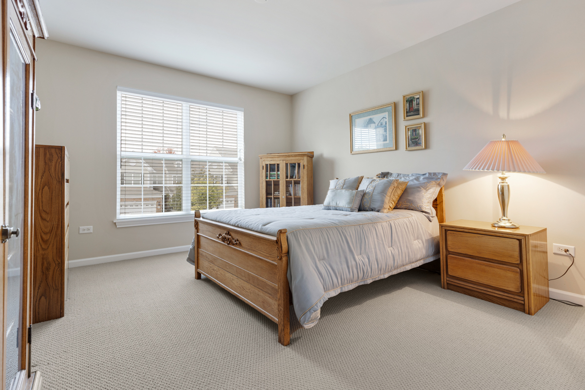 1127 Pine Valley Court Elgin, IL 60124 - Photo 17 of 27 a spacious bedroom with a bed and a window