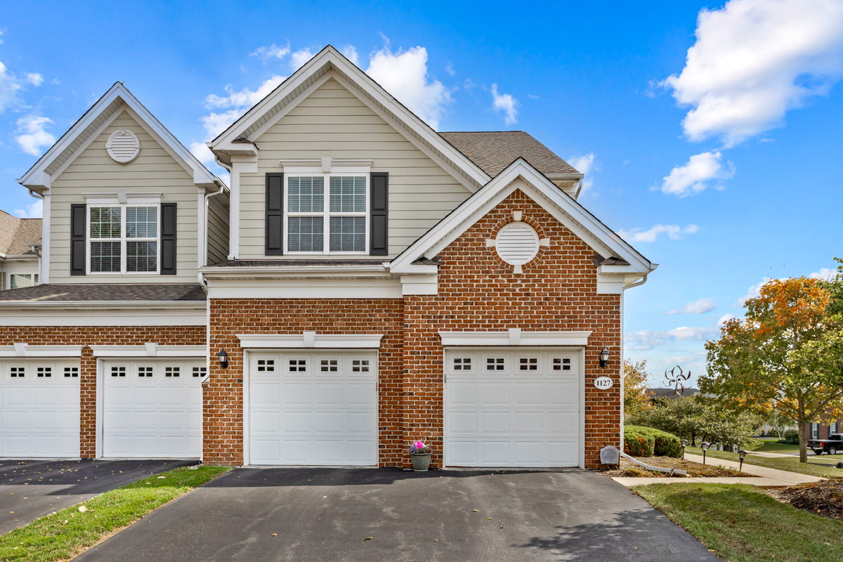 1127 Pine Valley Court Elgin, IL 60124 - Photo 2 of 27 a front view of a house with a yard and garage