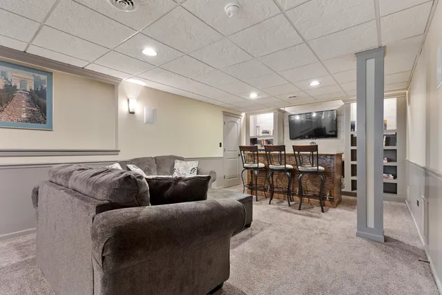 a living room with furniture and a large mirror