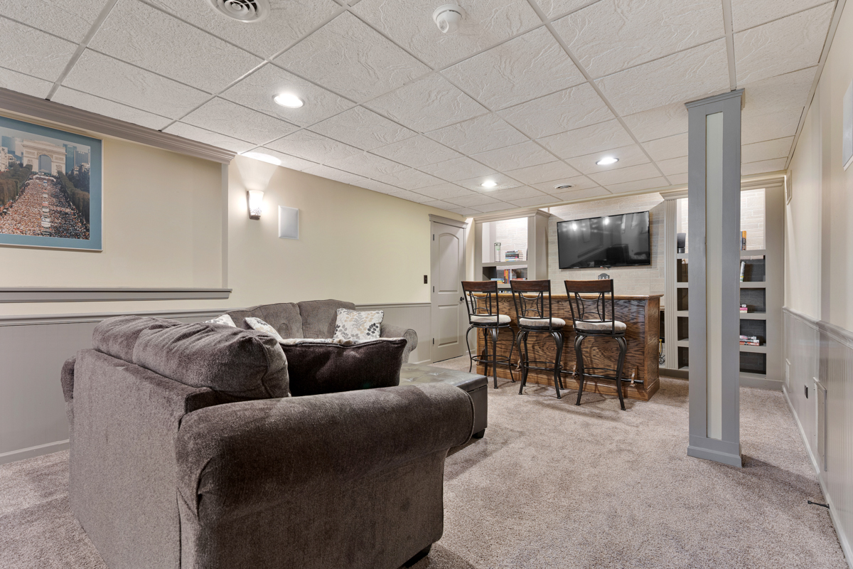 1127 Pine Valley Court Elgin, IL 60124 - Photo 21 of 27 a living room with furniture and a large mirror