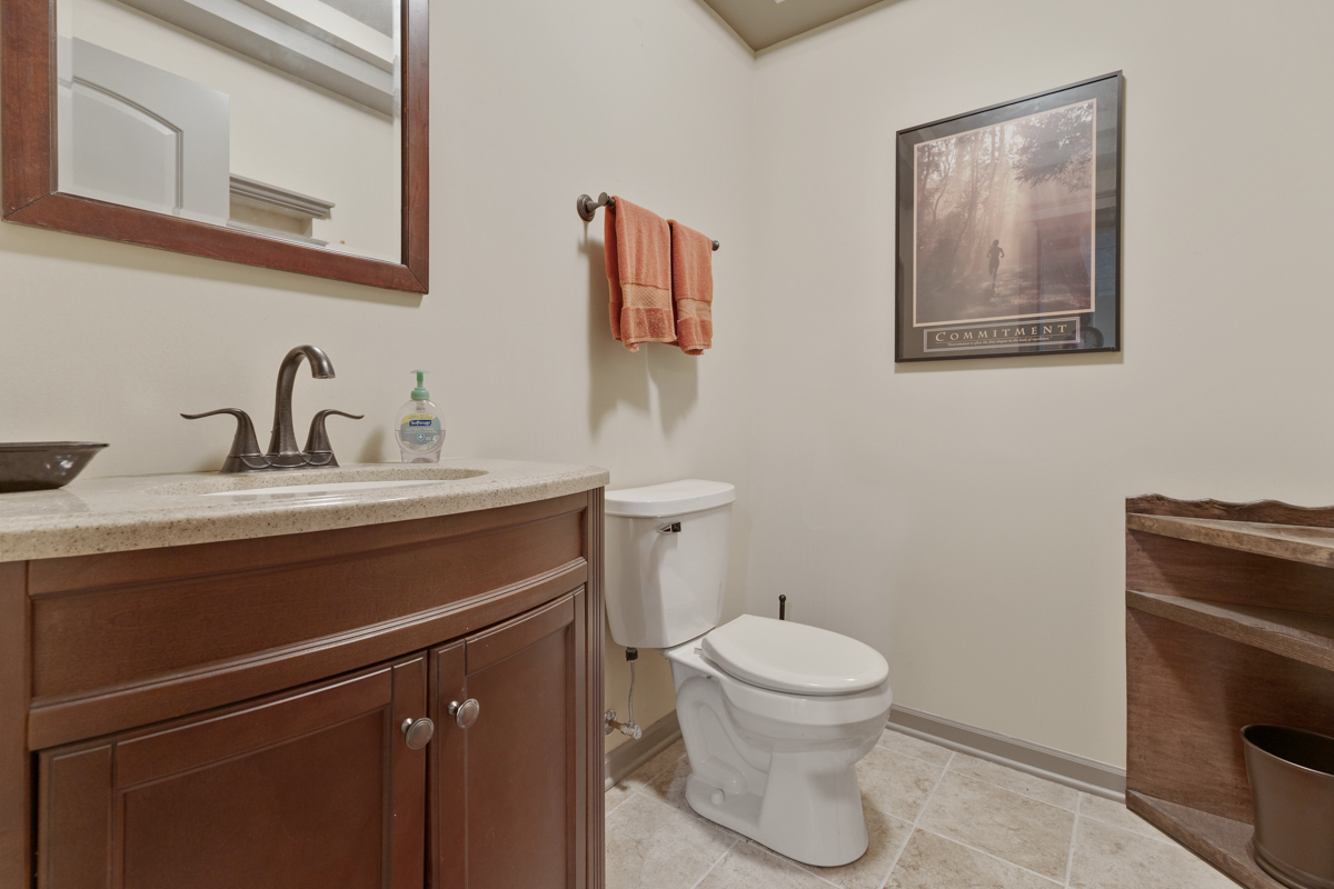 1127 Pine Valley Court Elgin, IL 60124 - Photo 24 of 27 a bathroom with a toilet sink and mirror