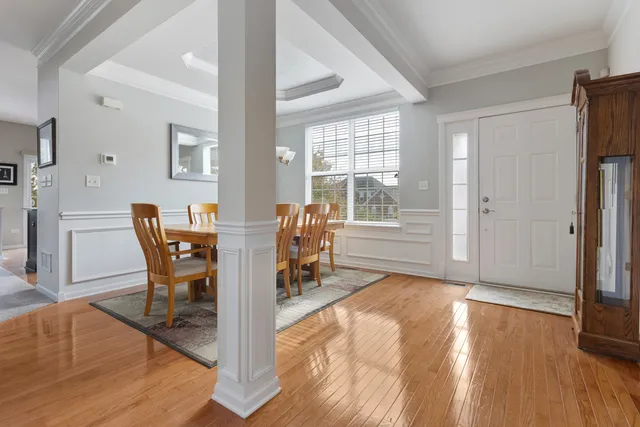 a dining room with furniture and wooden floor