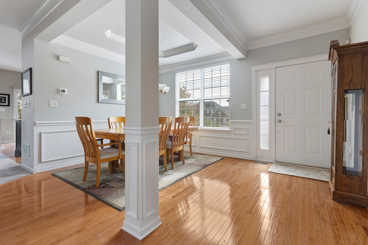 1127 Pine Valley Court Elgin, IL 60124 - Photo 3 of 27 a dining room with furniture and wooden floor