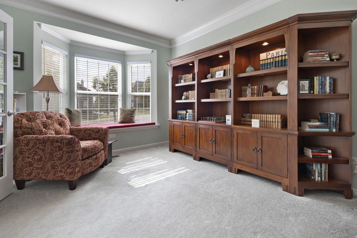 1127 Pine Valley Court Elgin, IL 60124 - Photo 5 of 27 a living room with furniture and a book shelf