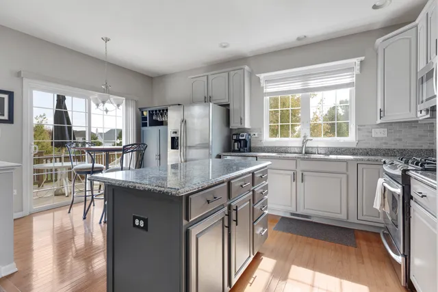 a kitchen with granite countertop counter top space a sink stainless steel appliances and cabinets