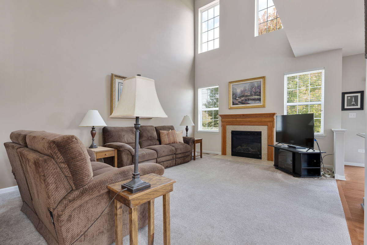 1127 Pine Valley Court Elgin, IL 60124 - Photo 10 of 27 a living room with furniture and a fireplace