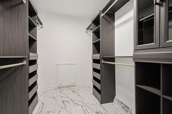 walk in closet with wooden floor