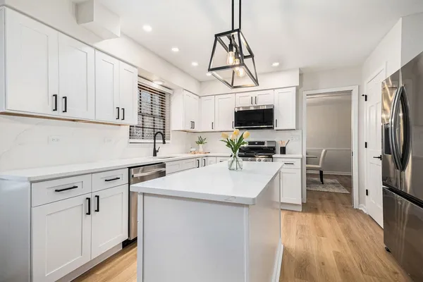 a kitchen with stainless steel appliances a stove sink microwave and cabinets