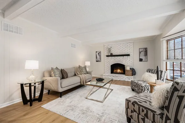 a living room with furniture and a fireplace