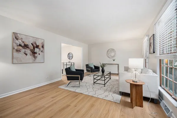 a living room with furniture a rug and a wall painting
