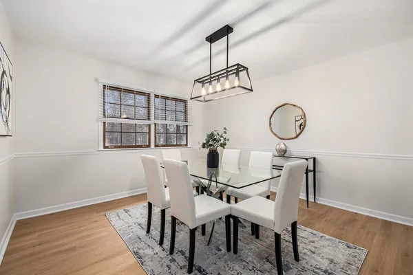 a view of a dining room with furniture window and wooden floor