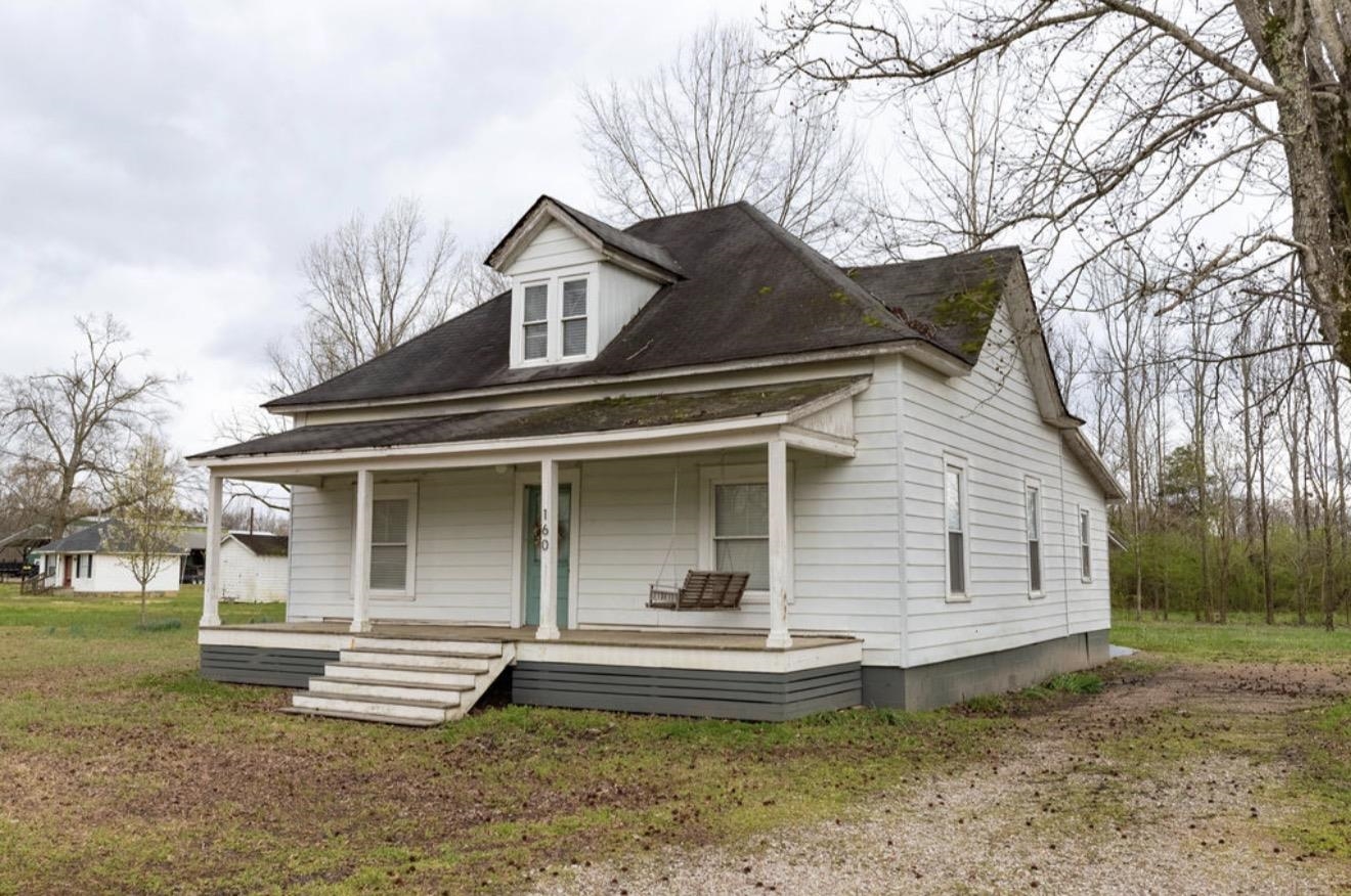 160 Chewalla Road Ramer, TN 38367 - Photo 37 of 39 View of front of property featuring covered porch, a shingled roof, and a front yard