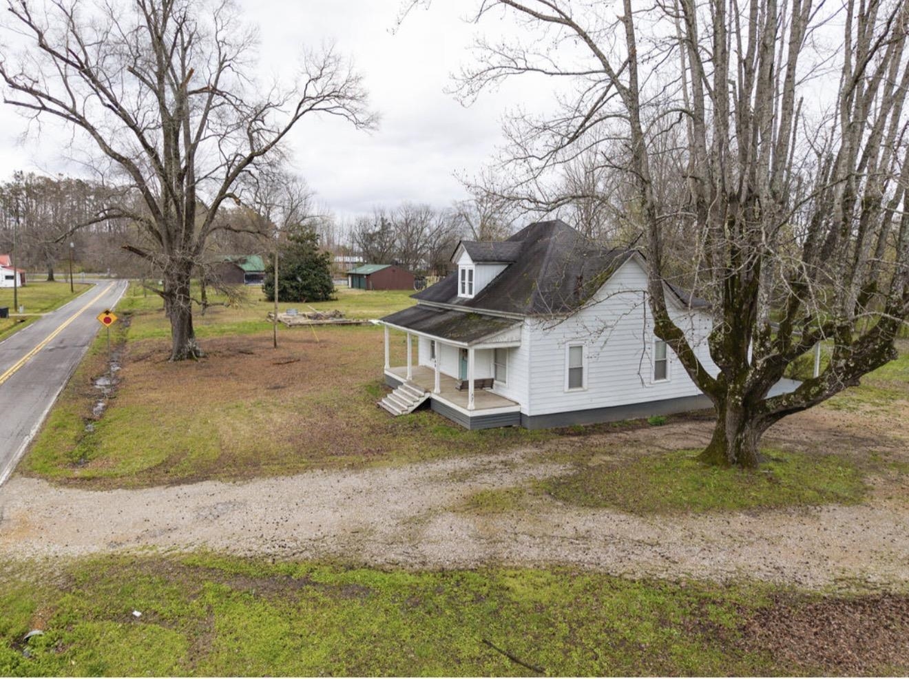 160 Chewalla Road Ramer, TN 38367 - Photo 38 of 39 View of side of property with covered porch and a yard