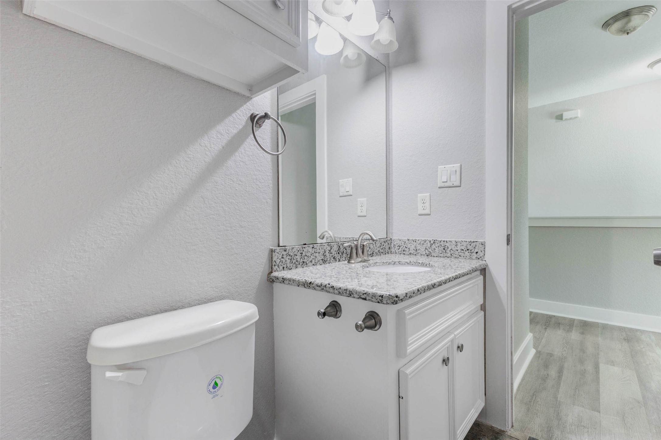 4834 Hollow Hook Road, Unit A Houston, TX 77041 - Photo 23 of 30 a bathroom with a granite countertop sink a toilet and a mirror