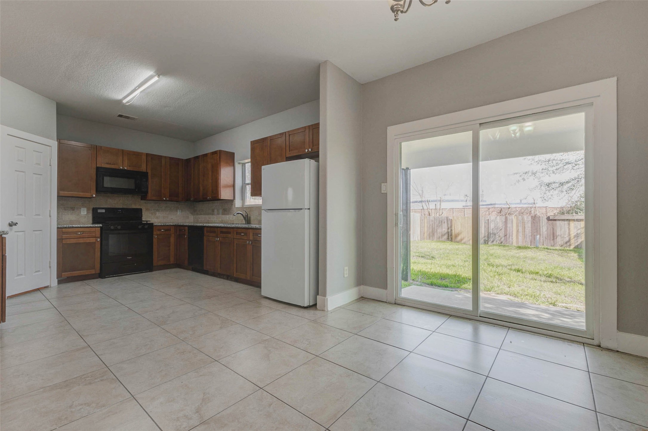 4834 Hollow Hook Road, Unit A Houston, TX 77041 - Photo 6 of 30 a large kitchen with a stove a refrigerator and a view of kitchen