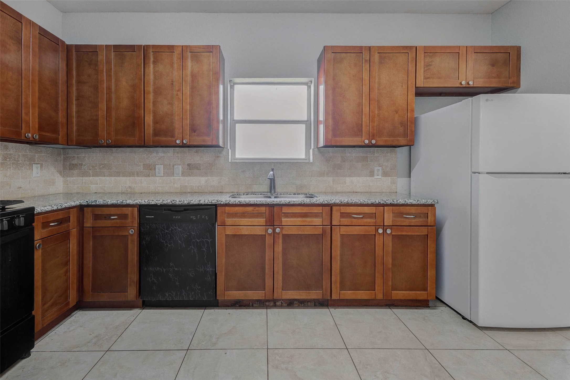 4834 Hollow Hook Road, Unit A Houston, TX 77041 - Photo 9 of 30 a kitchen with a cabinets and a refrigerator