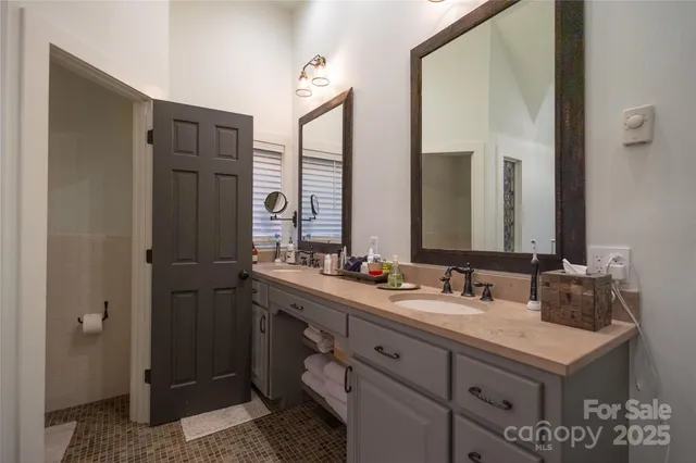 a bathroom with a double vanity sink and mirror