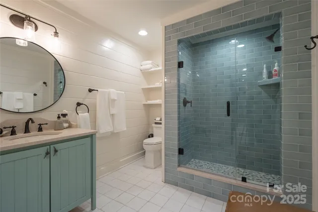 a bathroom with a sink mirror toilet and shower