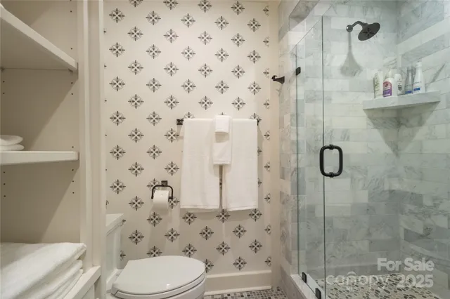 a bathroom with a toilet and shower