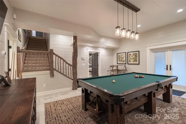 a room with furniture pool table and flat screen tv