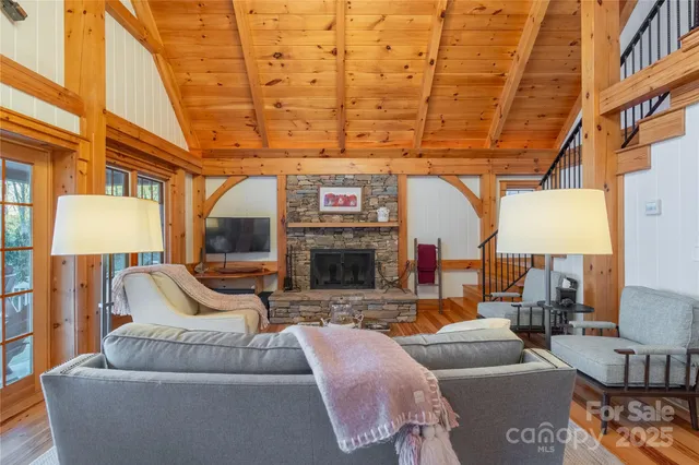 a living room with furniture a large window and a fireplace