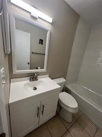 a bathroom with a sink toilet and mirror