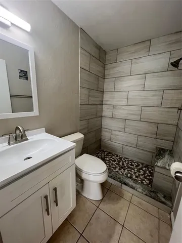 a bathroom with a sink toilet and shower