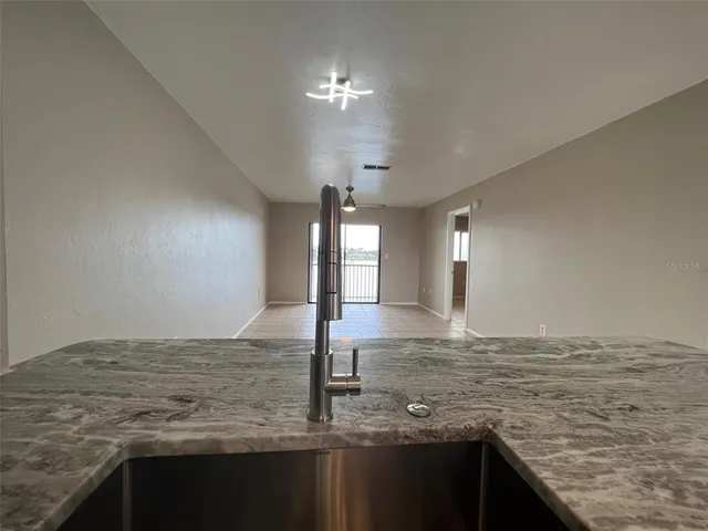 a view of a kitchen island a sink and a stove