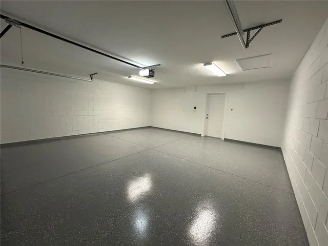 a bathroom with a granite countertop sink and a washing machine